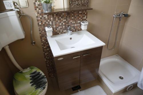 a small bathroom with a sink and a toilet at Apartment Tina in Vodice