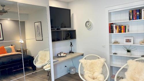 a bedroom with a bed and a desk and chairs at River cottage in Blairgowrie