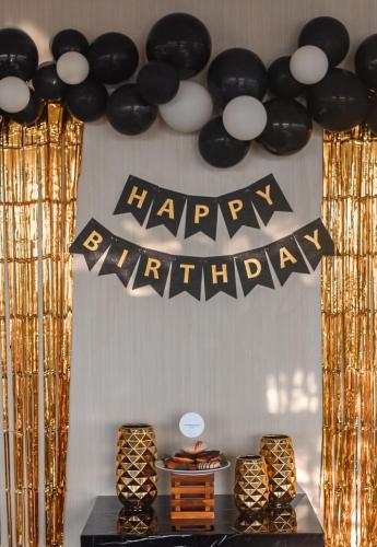 a happy birthday banner with black and white balloons at BeSS Mansion Hotel Surabaya in Wonocolo