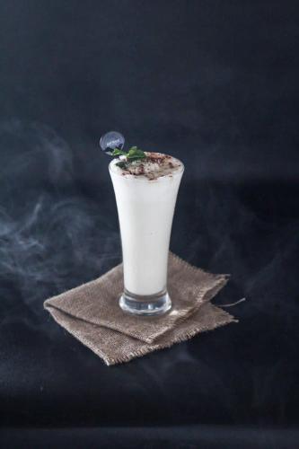 a drink sitting on top of a napkin at BeSS Mansion Hotel Surabaya in Wonocolo
