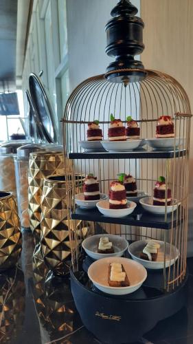 a plate of desserts in a bird cage at BeSS Mansion Hotel Surabaya in Wonocolo