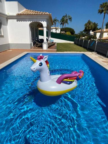 a unicorn float in a swimming pool at Villa Med - private pool, garden, sun all day, stunning views in Albufeira