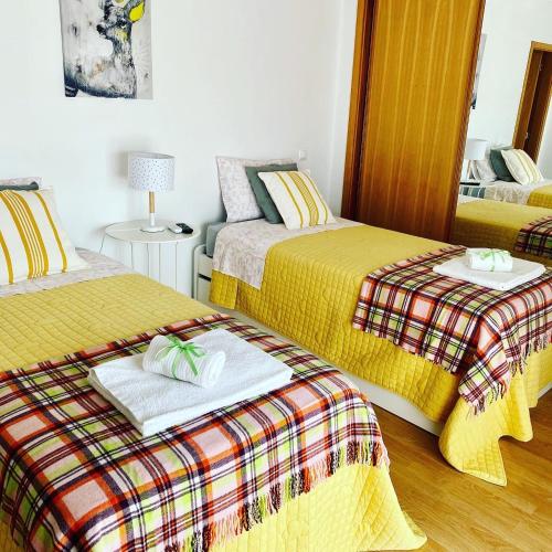 a bedroom with two beds with towels and a table at Villa Med - private pool, garden, sun all day, stunning views in Albufeira