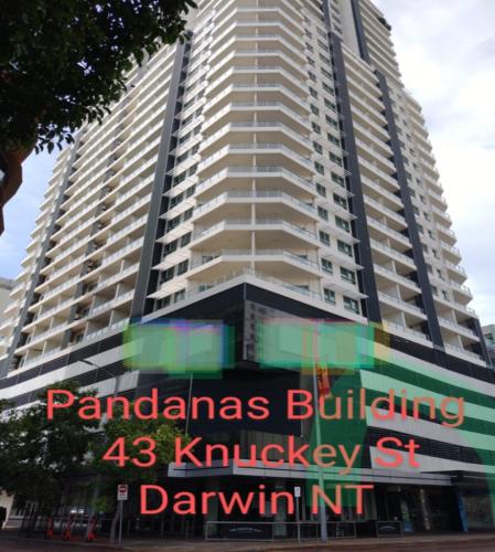 a tall building with a sign in front of it at Darwin Harbour Suites in Darwin
