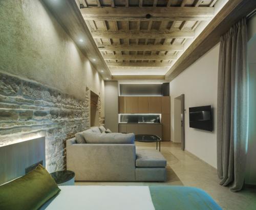 a living room with a couch and a fireplace at Apartamentos Los Patios del Pañuelo in Córdoba