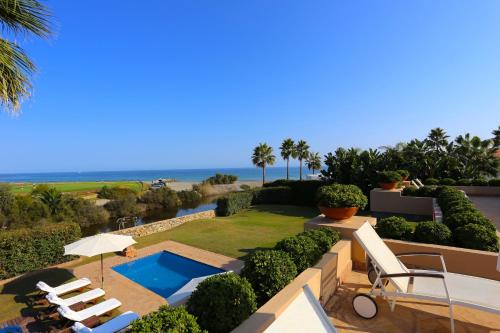 a resort with a swimming pool and the ocean at Las Ranas CASASOLA BEACH & GOLF VILLA in Estepona