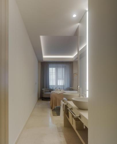 a bathroom with a tub and a sink and a mirror at Apartamentos Los Patios del Pañuelo in Córdoba