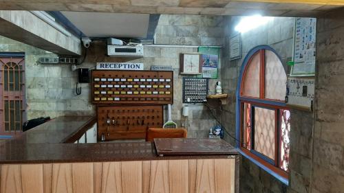 a view of a bar in a restaurant with a window at PREMIER MANSION in Chennai
