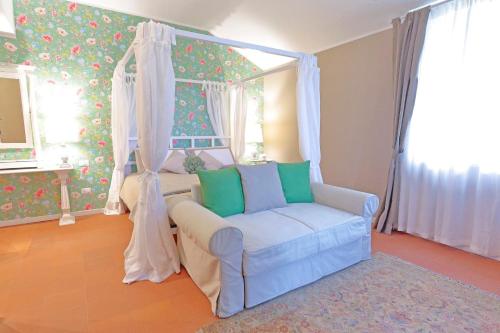 a bedroom with a bed with a chair and a canopy at Agriturismo Tenuta "Il Cigno" in Villanterio