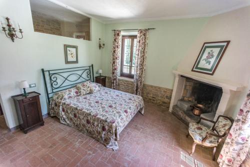 a bedroom with a bed and a fireplace at Villa Ca de Poi - Tabiano Castle Country Villas in Salsomaggiore Terme