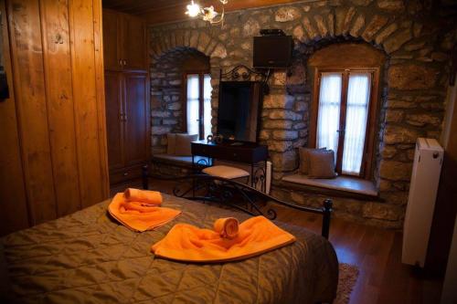 a bedroom with a bed with towels on it at Despotikon Dimitsana Guest house - Ξενώνας Δεσποτικόν Αντωνόπουλου in Dhimitsana