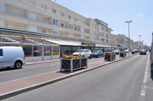 a street with cars parked in front of a building at imperatrice 2 in Berck-sur-Mer