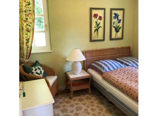 a bedroom with a bed and a lamp on a table at Landhaus Finest Haus Weickenhof in Velburg