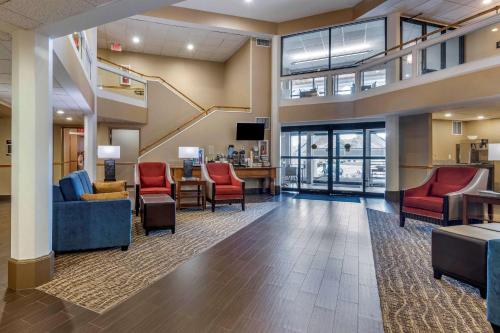 a lobby with red chairs and a waiting room at Comfort Inn & Suites Montpelier-Berlin in Montpelier