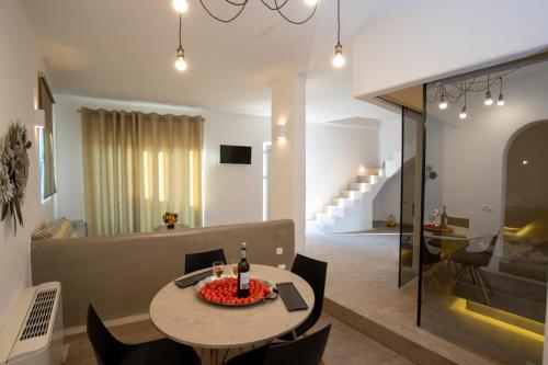 a dining room and living room with a table and chairs at Thea Luxury Resort in Fira