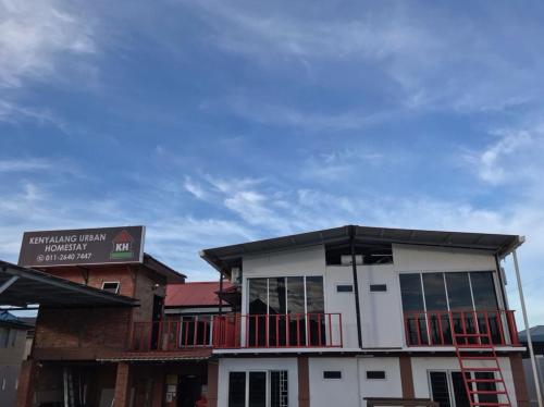 a building with a balcony on top of it at Kenyalang Urban Homestay in Kuching
