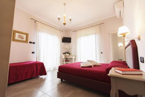 a bedroom with a red bed and a table at San Nicola in Agerola