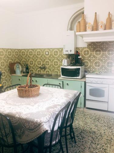 a kitchen with a table with a basket on it at Monte de Stª Margarida in Montemor-o-Novo