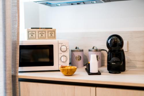 a microwave sitting on top of a kitchen counter at MC Suite Relax in Polignano a Mare