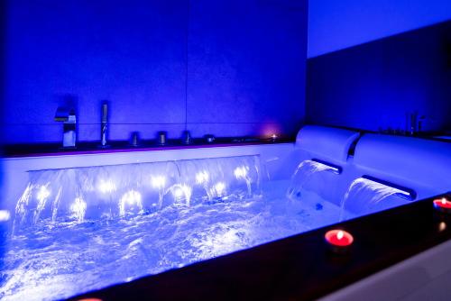 a bathroom with a tub filled with water with lights at MC Suite Relax in Polignano a Mare