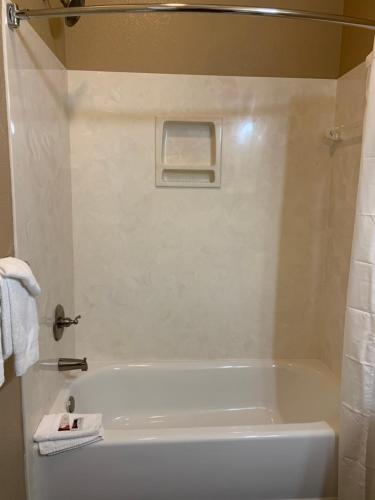 a white bath tub in a bathroom with a shower at Carr's Northside Hotel and Cottages in Gatlinburg
