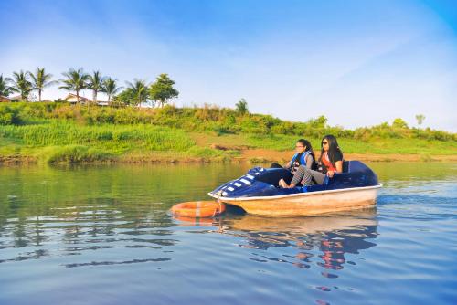 two women sitting on a raft in the water at Anchaviyo Resort in Vāda