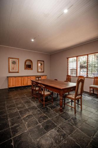 a large room with a wooden table and chairs at Linvale Country Lodge in Hazyview