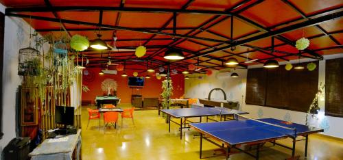 a ping pong room with ping pong tables in it at Anchaviyo Resort in Vāda