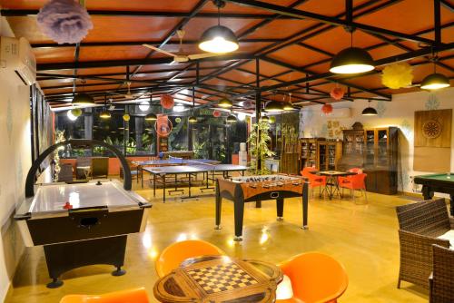 a large room with ping pong tables and ping pong tablesktop at Anchaviyo Resort in Vāda