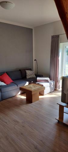 a living room with a couch and a coffee table at Ferienwohnung Matzibarg in Ahrenviöl