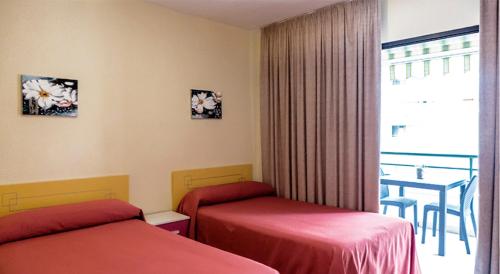 Postel nebo postele na pokoji v ubytování Hostal Rosa