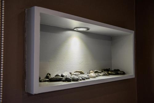aessedessed shelf with rocks on it with a light at Dunnet B&B Escapes in Dunnet