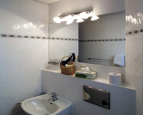 a bathroom with a sink and a mirror at Hotel Deisterblick in Bad Nenndorf