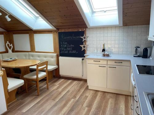a kitchen with a table and a dining room at Naturpark Appartment in Ratting