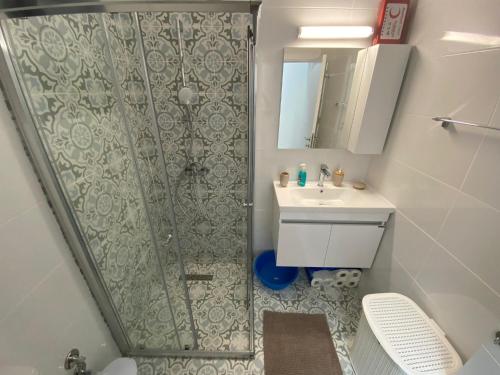 a small bathroom with a shower and a sink at Ceasar Resort Cyprus - Apartment Leona in Bahçeler