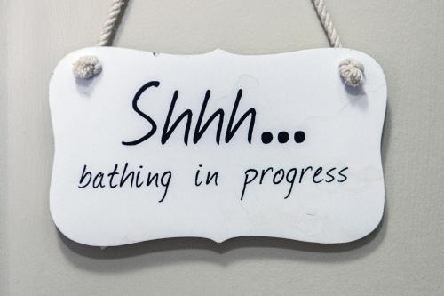 a sign that says shhhboarding in progress hanging on a wall at Dunnet B&B Escapes in Dunnet
