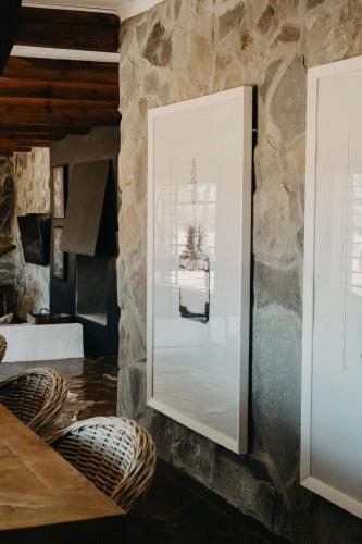a living room with a large mirror on the wall at Twyfelberg Karoo Hideaway in Britstown