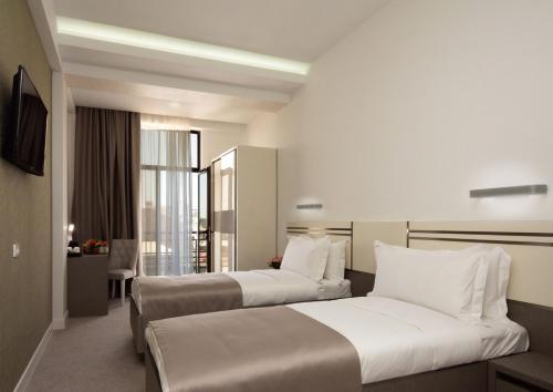 Postel nebo postele na pokoji v ubytování Dave Hotel Yerevan