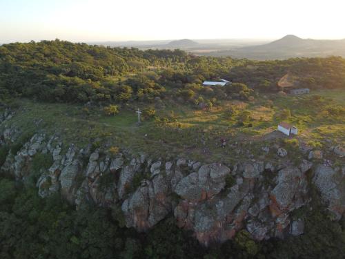 an aerial view of a rocky hill with a house on it at Nomada Hostel in Asuncion