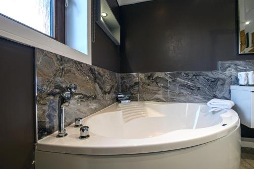 a bathroom with a tub and a sink at Dunnet B&B Escapes in Dunnet