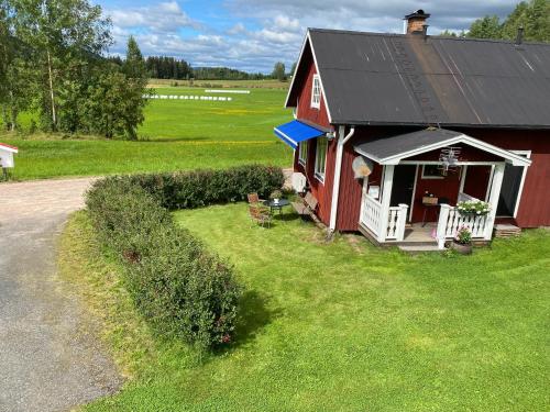 an overhead view of a red barn with a porch at Backen in Torsby