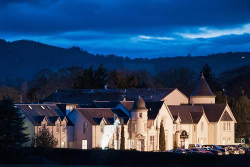 a large building with cars parked in front of it at Kingsmills Hotel in Inverness