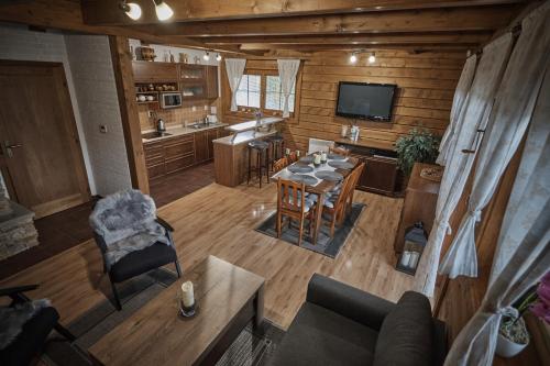 an overhead view of a living room and kitchen with a table and chairs at Chata Vŕšky Terchová in Terchová