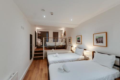 two beds in a room with a bedroom at Lord Street Apartments By Happy Days in Liverpool