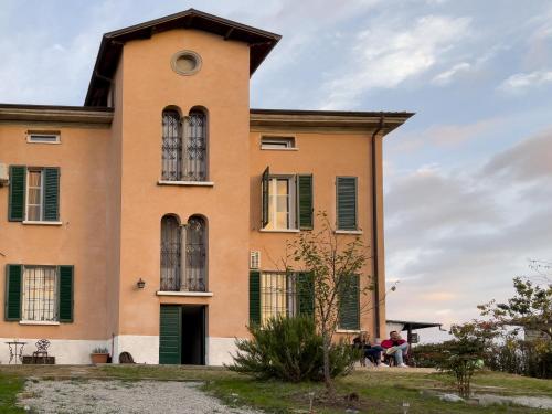 a building with people sitting outside of it at Notte Rosa Suites & Relax in Fornovo di Taro