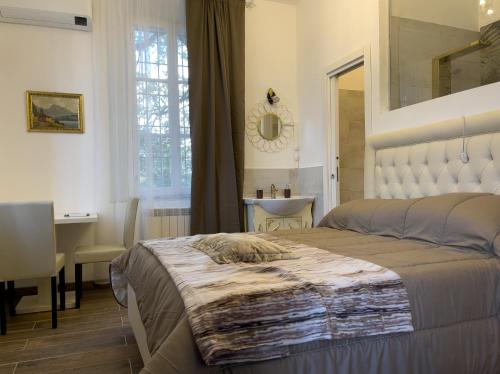 a bedroom with a bed and a desk and a mirror at Notte Rosa Suites & Relax in Fornovo di Taro