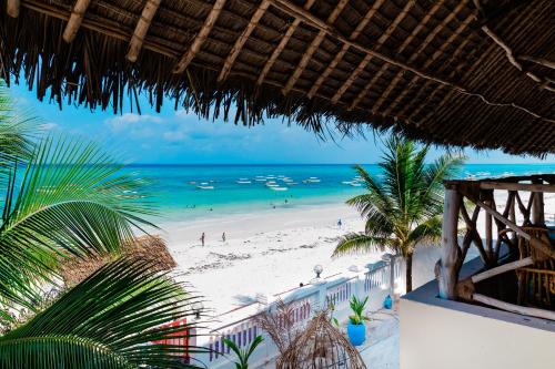 a view of the beach from a resort balcony at Mambo Paradise in Matemwe