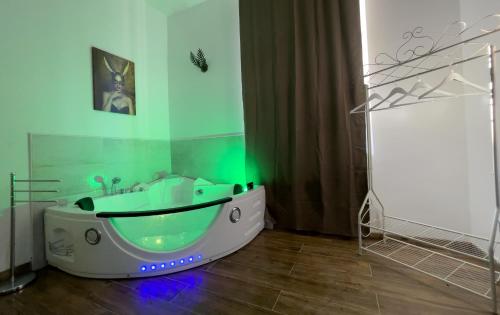 a bathroom with a bath tub with a green light at Notte Rosa Suites & Relax in Fornovo di Taro