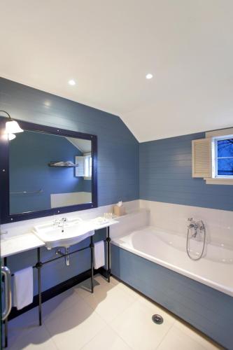 a bathroom with a tub and a sink at Millbrook Resort in Arrowtown