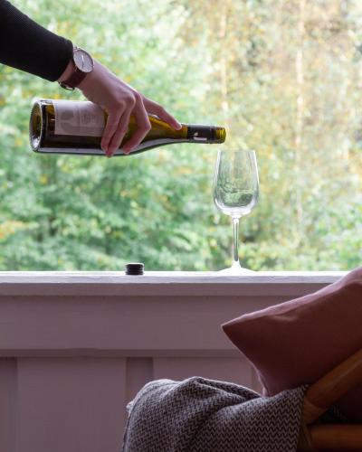 a person pouring a bottle of wine into a wine glass at Gut Moorbeck in Amelhausen